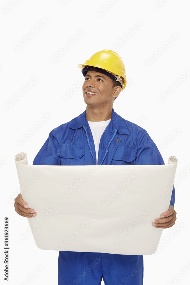 Construction worker looking at a blueprint plan Construction worker looking at a blueprint plan