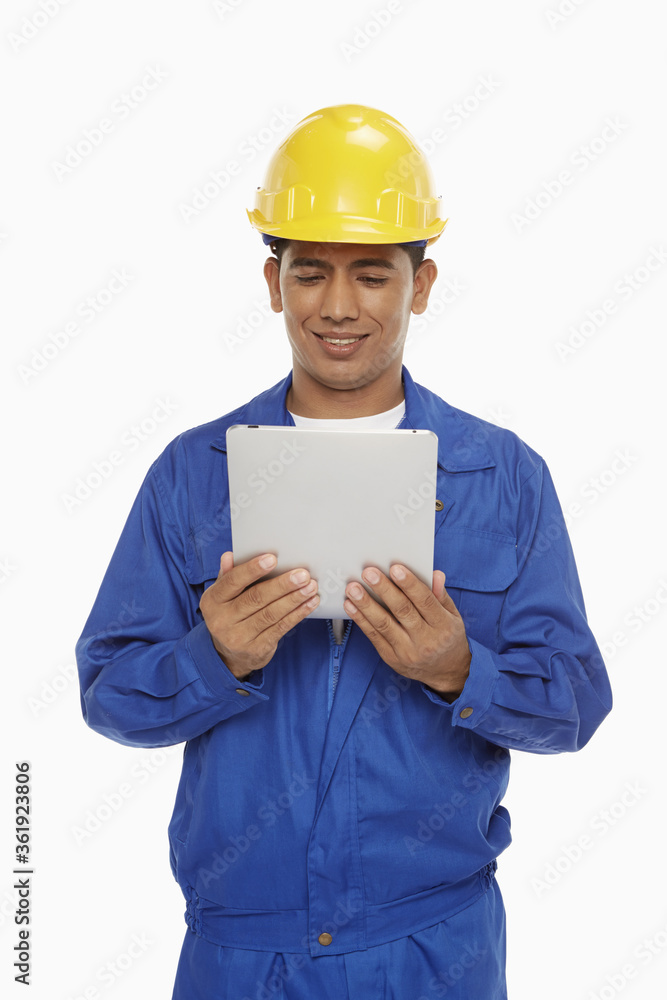 Construction worker using a digital tablet Construction worker using a digital tablet