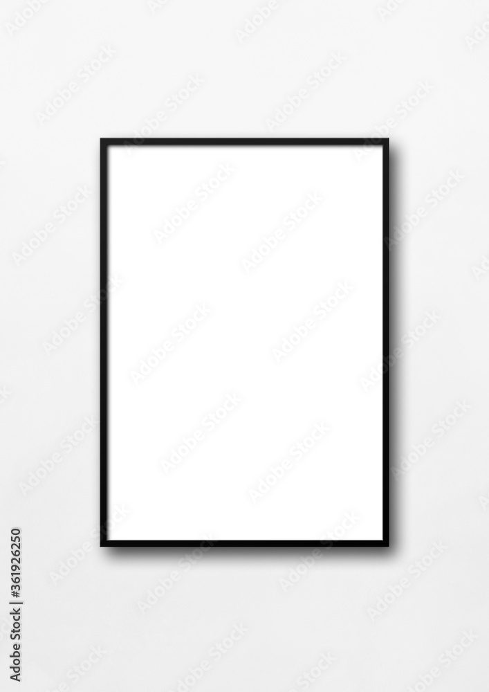 Black picture frame hanging on a white wall
