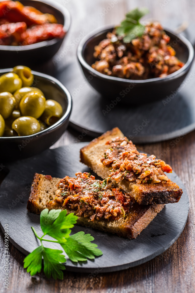 Crispy crostini with tapenade and ingredients. Crispy crostini with tapenade and ingredients.
