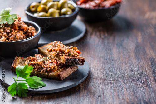 Crispy crostini with tapenade and ingredients. photo