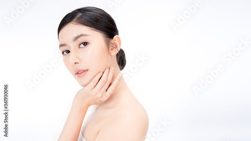 Fotografie Closeup portrait of beauty asian woman with fair perfect healthy glow skin hand touching shoulder copy space, young beautiful asia girl with pretty smile on face
