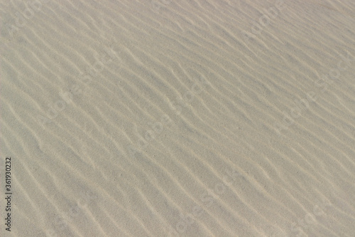 Wavy texture of white sand, background