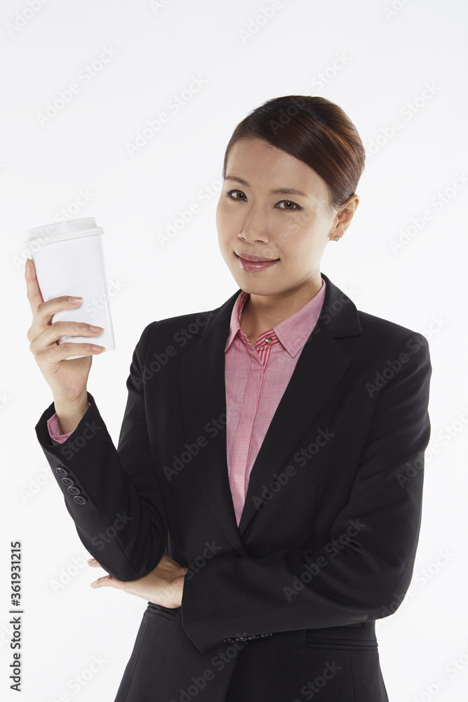 Businesswoman smiling and holding a disposable cup