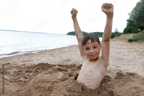 Kid on beach of Lake Seliger photo