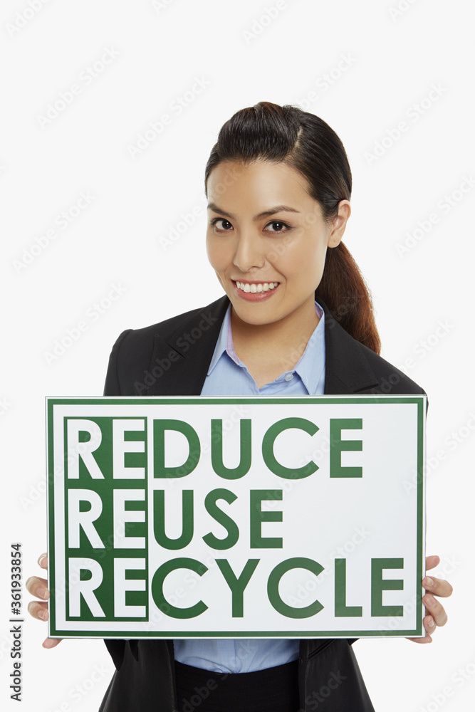 Businesswoman smiling and holding up a placard Businesswoman smiling and holding up a placard