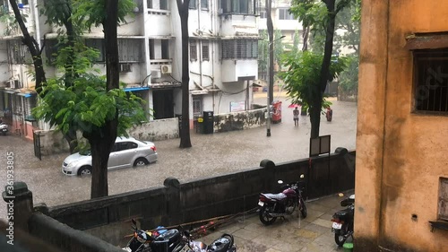 Time-lapse as a few men wade's through flooded water 