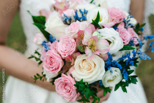 bride holding bouquet  the bride s bouquet  bride in wedding dress  bouquet of roses  wedding day