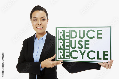 Businesswoman smiling and holding up a placard