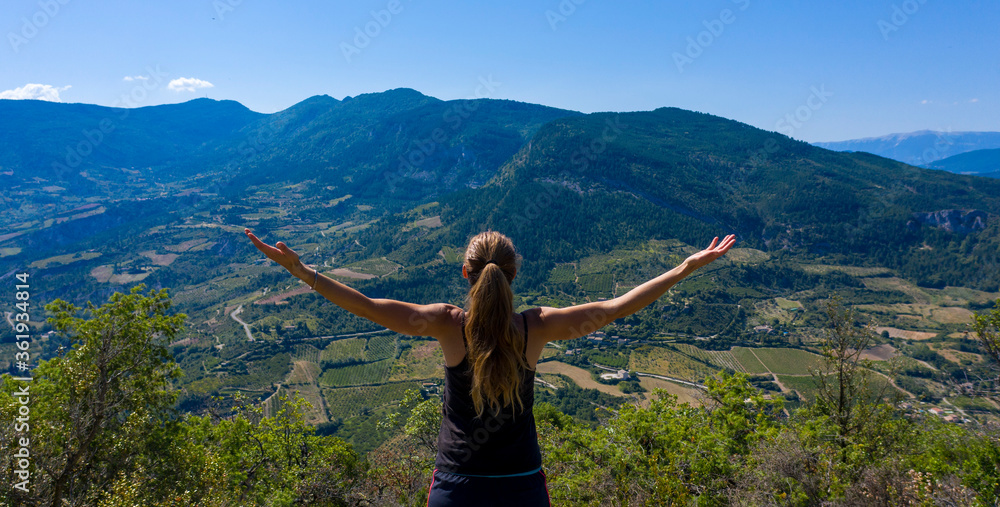 woman arm in air, looking beautiful landscape of France in Drome Provence