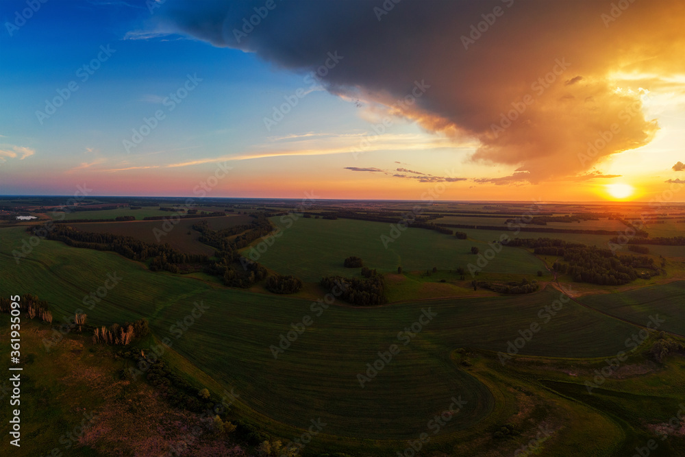 Aerial view on the field during sunset. Agricultural landscape from drone. Aerial view on the field during sunset. Agricultural landscape from drone.