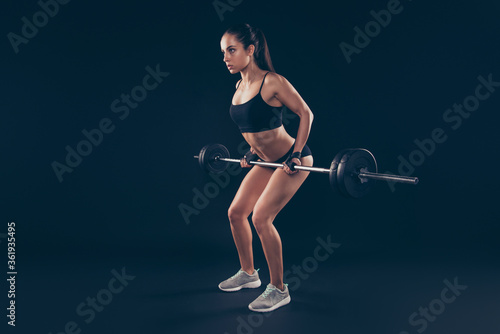 Full length profile photo short sport suit lady heavy barbell arms serious try hard ready win champion isolated black background