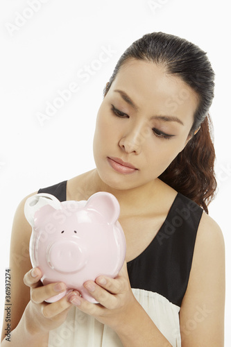 Woman holding up a piggy bank