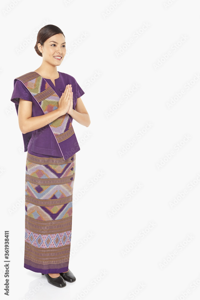 Woman in traditional clothing showing greeting gesture Woman in traditional clothing showing greeting gesture