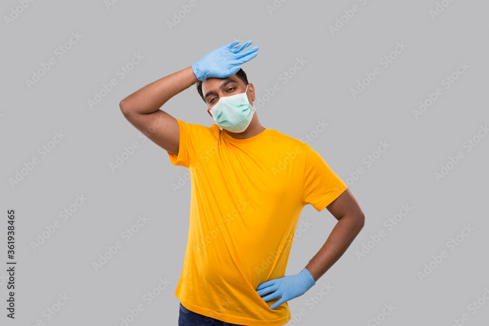 Fototapeta premium Indian Man Tired Sign Wearing Medical Mask and Gloves. Man WIping Sweat Isolated