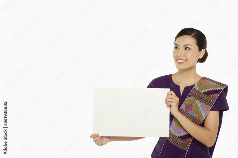 Woman in traditional clothing holding up a blank placard Woman in traditional clothing holding up a blank placard