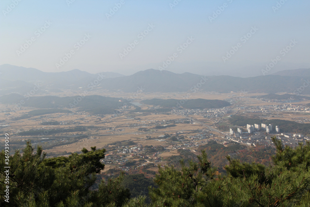 Gyeongju landscape with the buildings, mountains and paddy fields in autumn from Mt. Tohamsan, South Korea