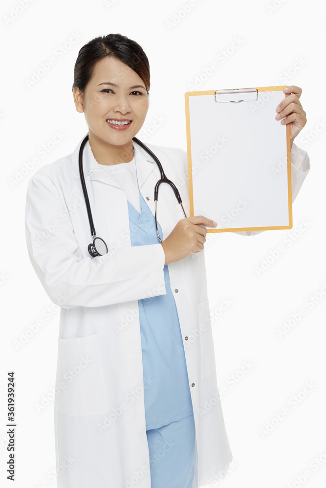 Medical personnel smiling and holding up a blank clipboard Medical personnel smiling and holding up a blank clipboard