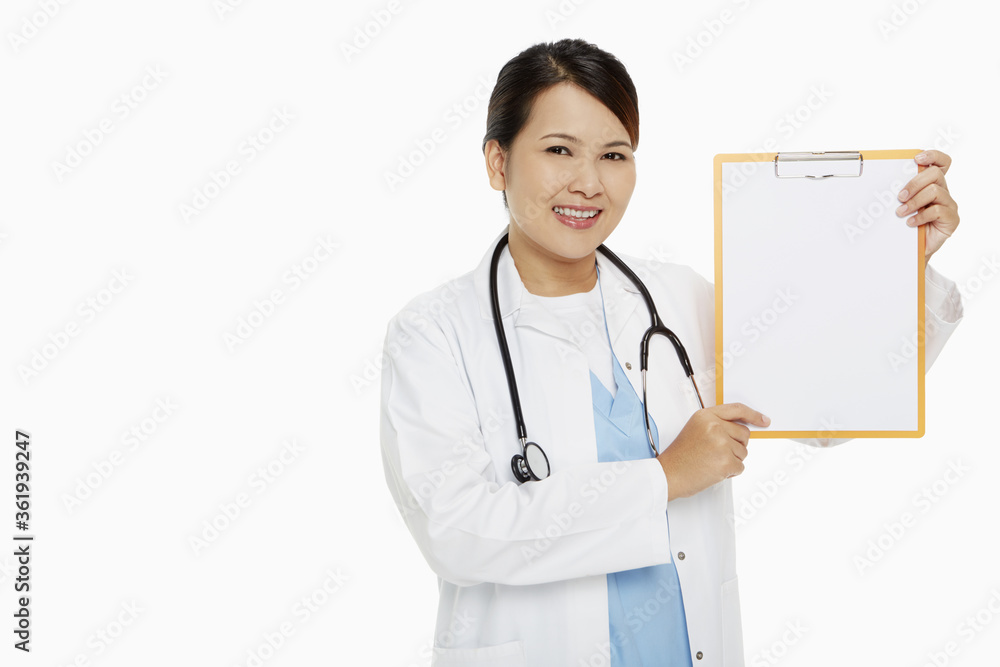 Medical personnel smiling and holding up a blank clipboard Medical personnel smiling and holding up a blank clipboard