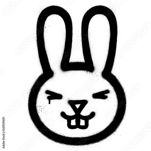 Graffiti smiling rabbit sprayed in black over white