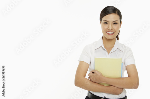 Cheerful woman carrying books