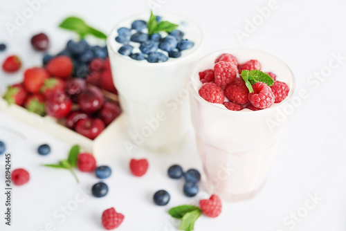 Yogurt cocktail and parfait. Natural detox. Liquid ice cream. Healthy food and breakfast. Good morning. Berry Milk Smoothie with blueberries, strawberries, raspberries. Fresh diet dessert. Summer card