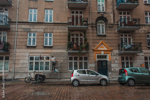 Cars on road near facade of building on urban street in Copenhagen, Denmark © LIGHTFIELD STUDIOS