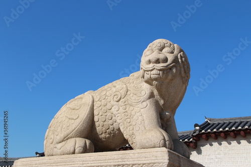 Mythological lion Haechi statue at Gyeongbokgung Palace gate in Seoul, South Korea