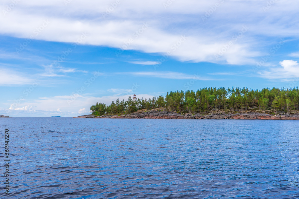 Picturesque summer landscape with northern lake coastline in cloudy day. Travelling and discovering distant places of Earth. View from water. Besov nos cape, Onega lake coast, Karelia, Russia Picturesque summer landscape with northern lake coastline in cloudy day. Travelling and discovering distant places of Earth. View from water. Besov nos cape, Onega lake coast, Karelia, Russia
