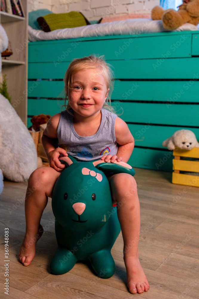 Funny child having fun in the children's studio sitting in toy Funny child having fun in the children's studio sitting in toy