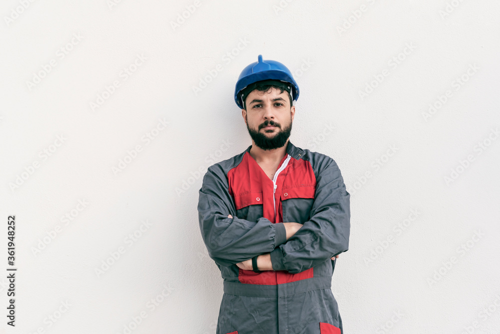 Construction worker portrait on white wall posing Construction worker portrait on white wall posing