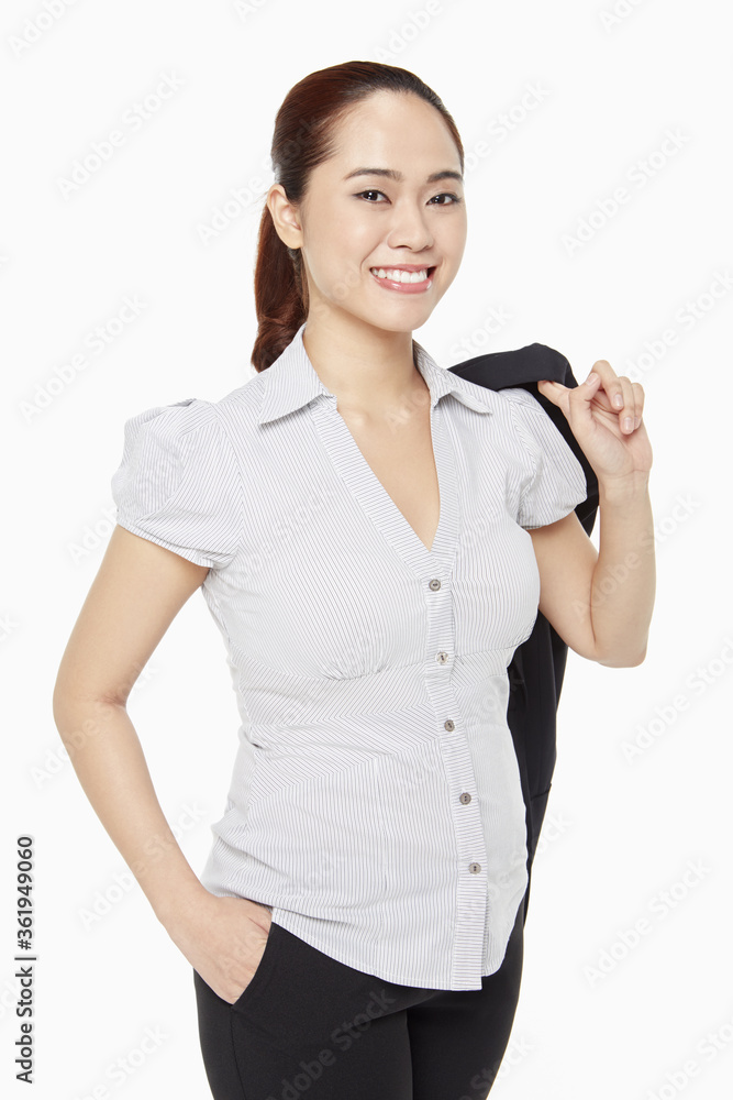 Businesswoman holding a jacket and smiling Businesswoman holding a jacket and smiling