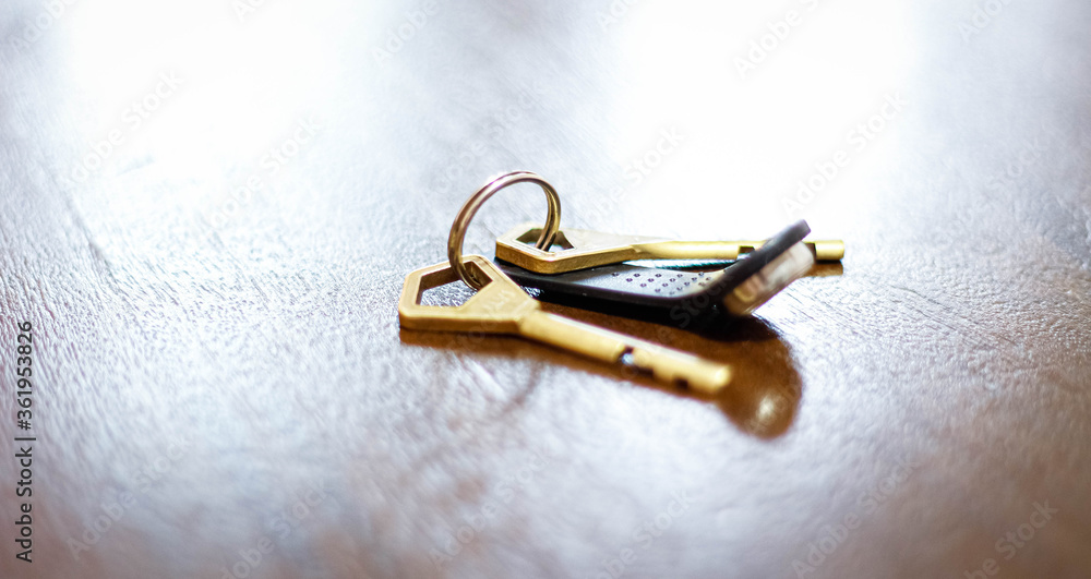 Keys to an apartment or house on a wooden table Keys to an apartment or house on a wooden table