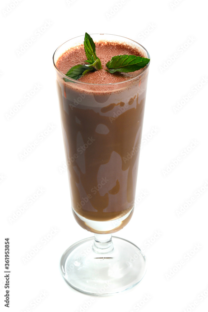 Chocolate milk shake in tall glass on white background garnished with mint leaves Chocolate milk shake in tall glass on white background garnished with mint leaves