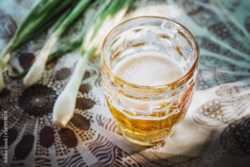 A glass of beer and green onions, the concept of a country holiday