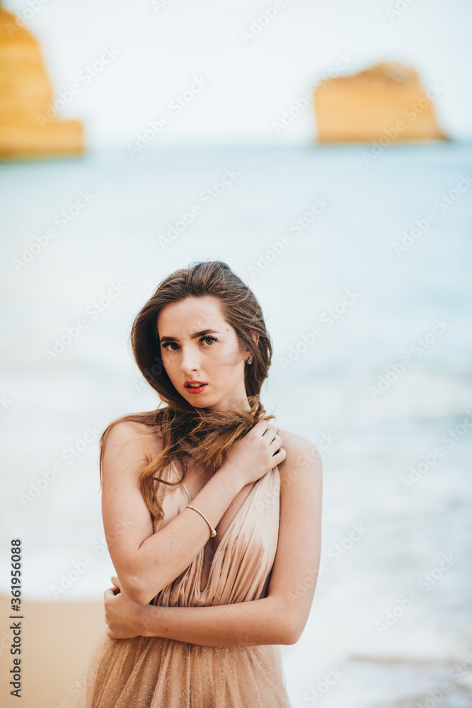 Happy Carefree Woman Enjoying Beautiful Sunset on the Beach