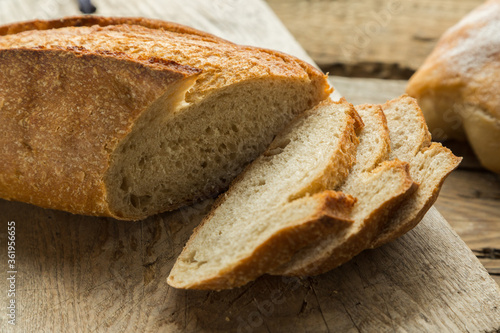 Homemade bread on cutting board, sliced and prepared for breakfast. Healthy lifestyle with fresh products without gmo.