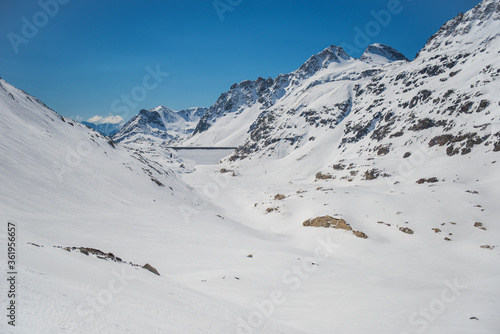 Spring alp scenery from Molltal glacier. Ski slope with skier in foggy april day.
