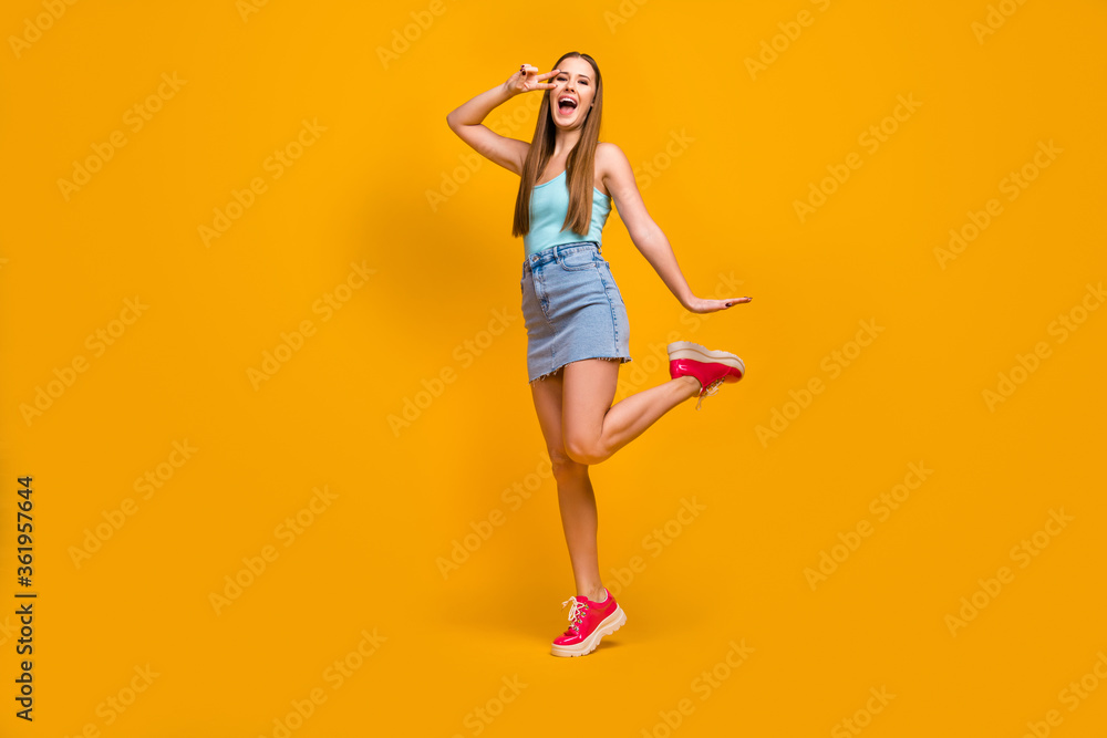 Full length body size view of her she nice attractive cheerful cheery overjoyed straight-haired girl having fun showing v-sign isolated over bright vivid shine vibrant yellow color background Full length body size view of her she nice attractive cheerful cheery overjoyed straight-haired girl having fun showing v-sign isolated over bright vivid shine vibrant yellow color background