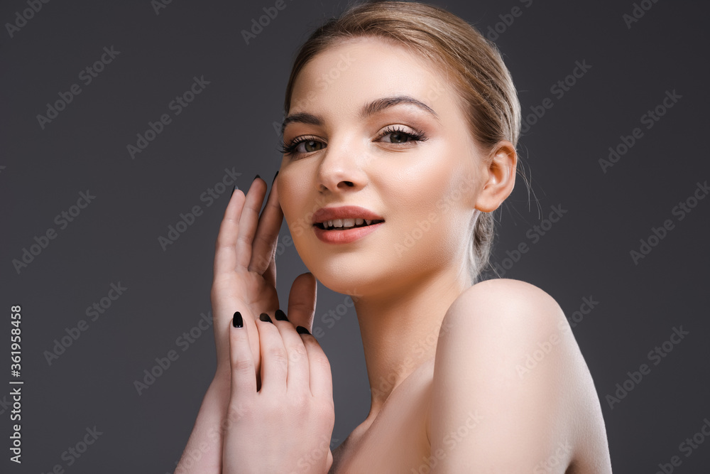 low angle view of happy naked woman looking at camera isolated on grey low angle view of happy naked woman looking at camera isolated on grey