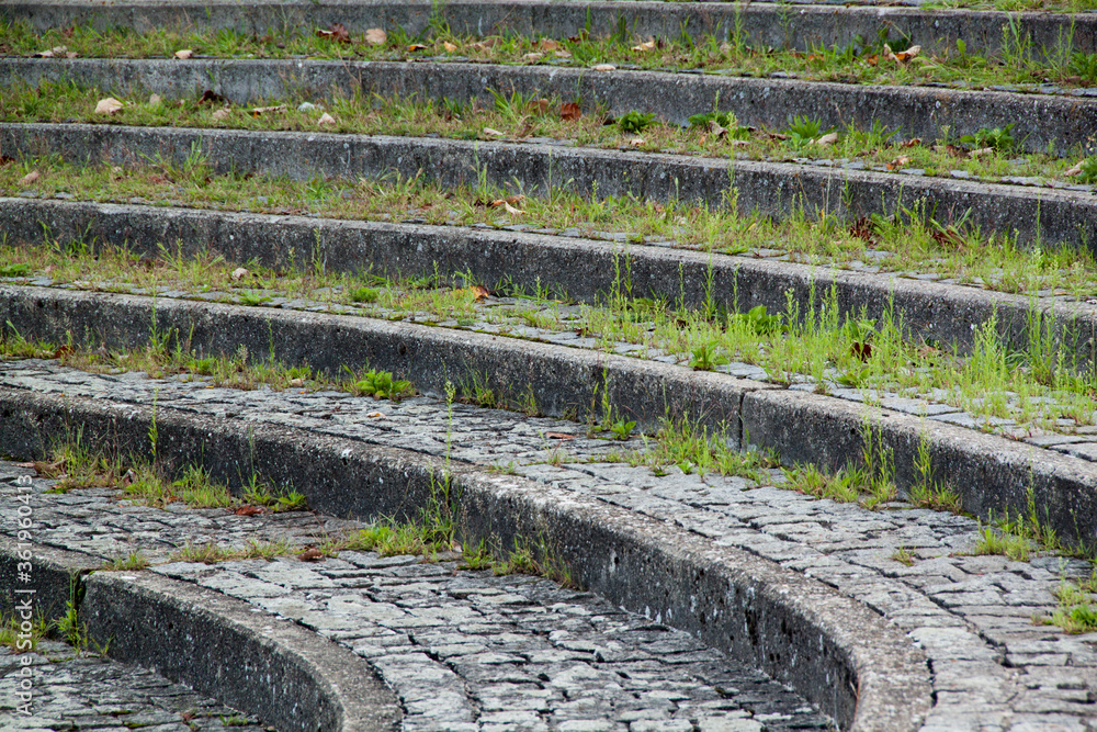 old stone steps in the park with grass