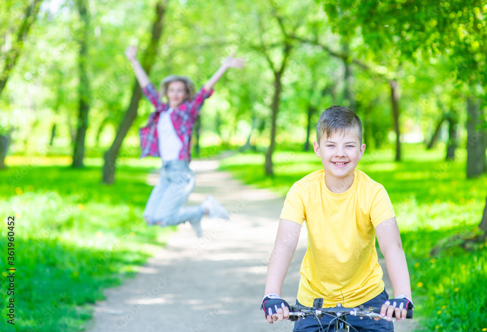 Happy family. Mother rejoices that her son learned to ride a bike