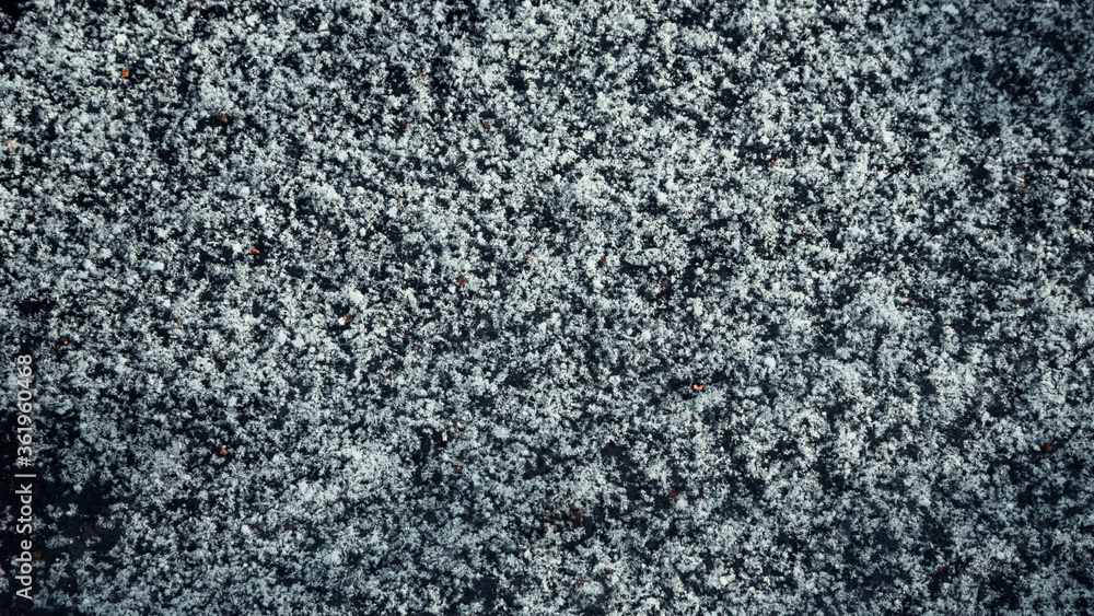 Rare snow lies in a thin layer on the surface of the earth