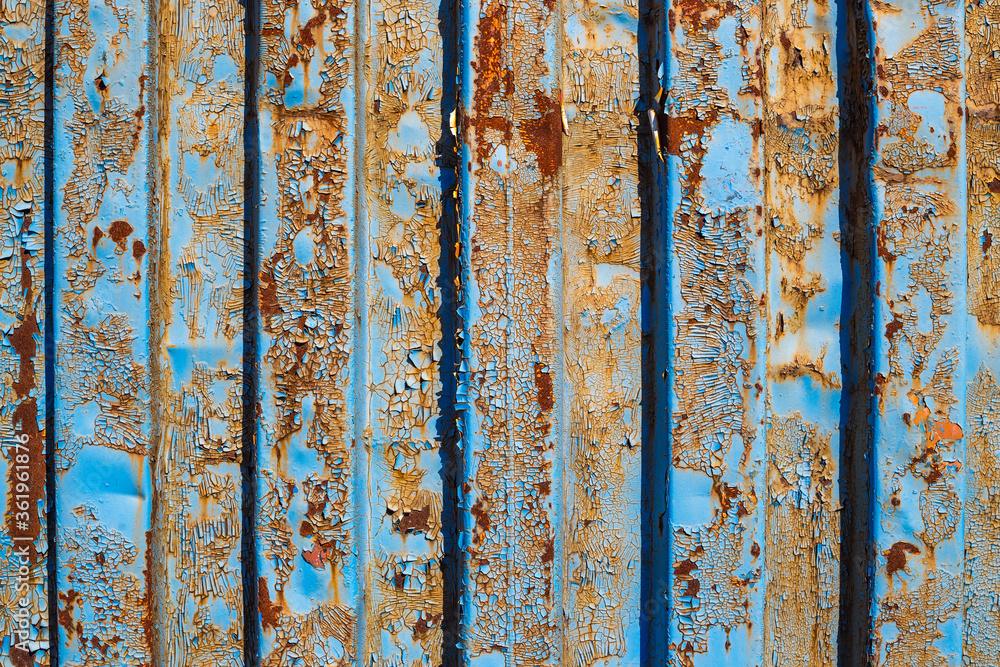 Texture of old rusty corrugated metal surface with peeling blue paint. Perfect for background and grunge design.