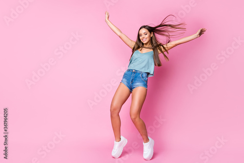 Full length body size view of her she nice attractive fascinating gorgeous cheerful dreamy brown-haired girl having fun standing in front of windy weather isolated over pink pastel color background