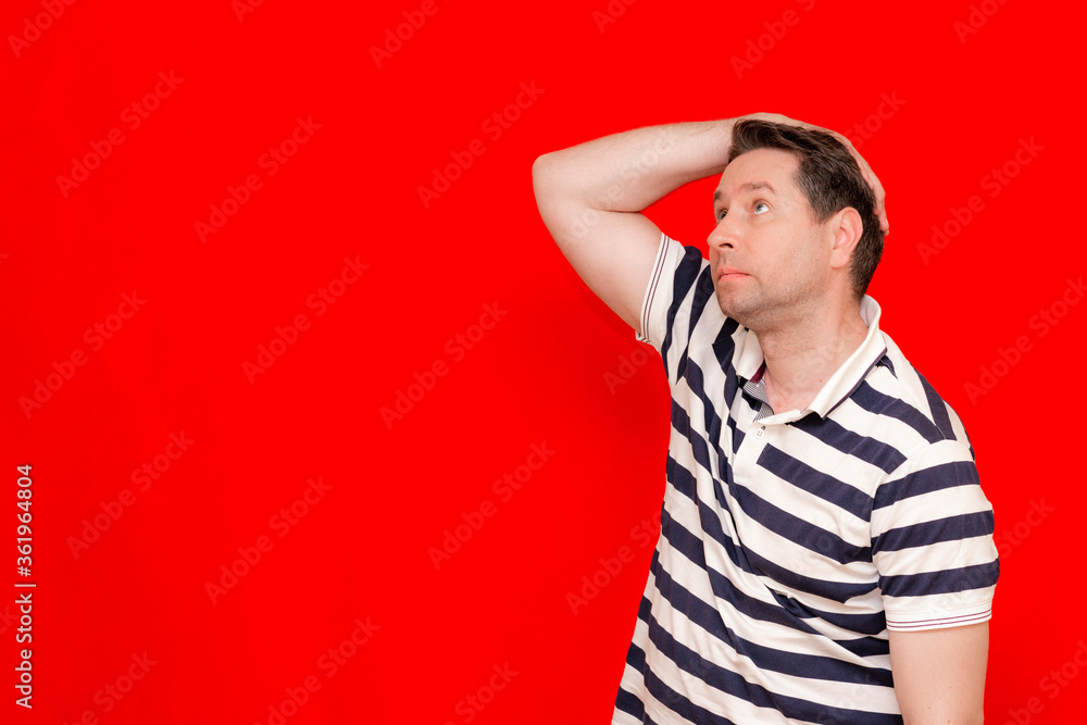 Upset 30s american man wearing striped t-shirt standing depressed and worry for distress, crying angry and afraid. Upset 30s american man wearing striped t-shirt standing depressed and worry for distress, crying angry and afraid.