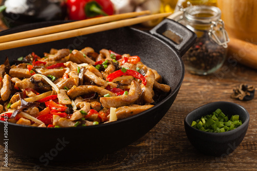 Pork chop with peppers, mushrooms and bamboo. Served with rice.