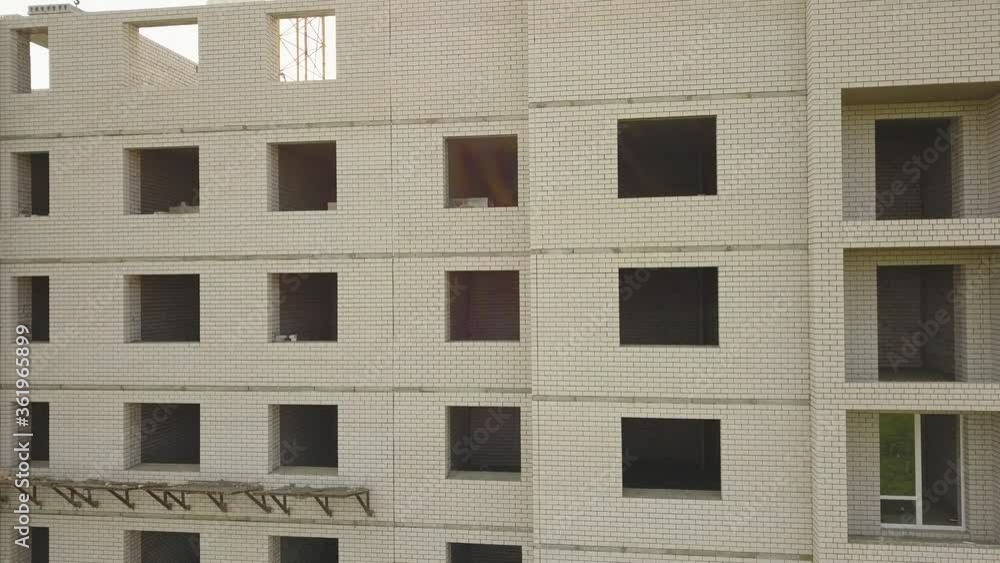 A flying camera removes the empty windows of a building under construction. A flying camera removes the empty windows of a building under construction.