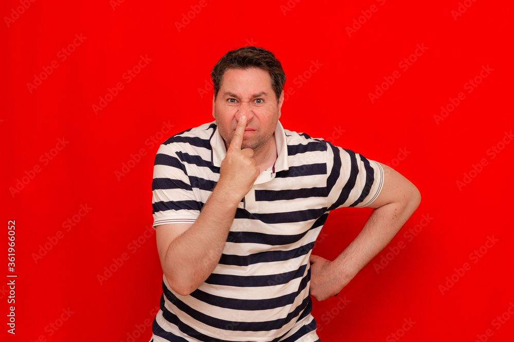 35s angry unshaved man wearing striped t-shirt something stinky and disgusting, intolerable smell 35s angry unshaved man wearing striped t-shirt something stinky and disgusting, intolerable smell