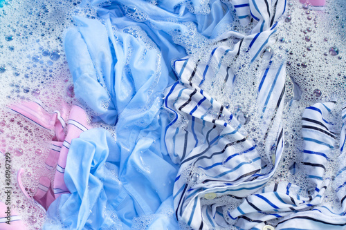 Obraz na plátně Color clothes soak in powder detergent water dissolution